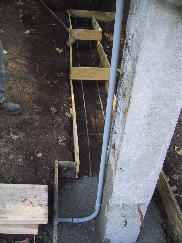 Electrical conduit exits the form into the dirt