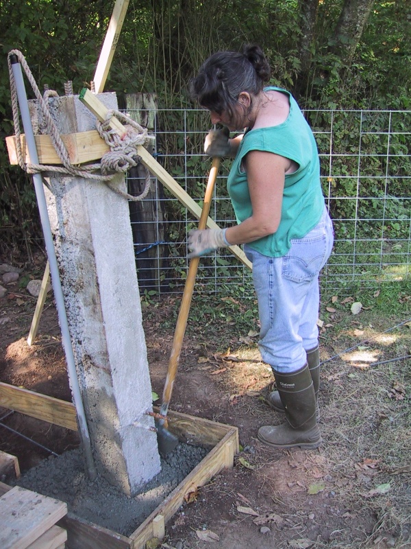 Stuffing the gate post hole with concrete
